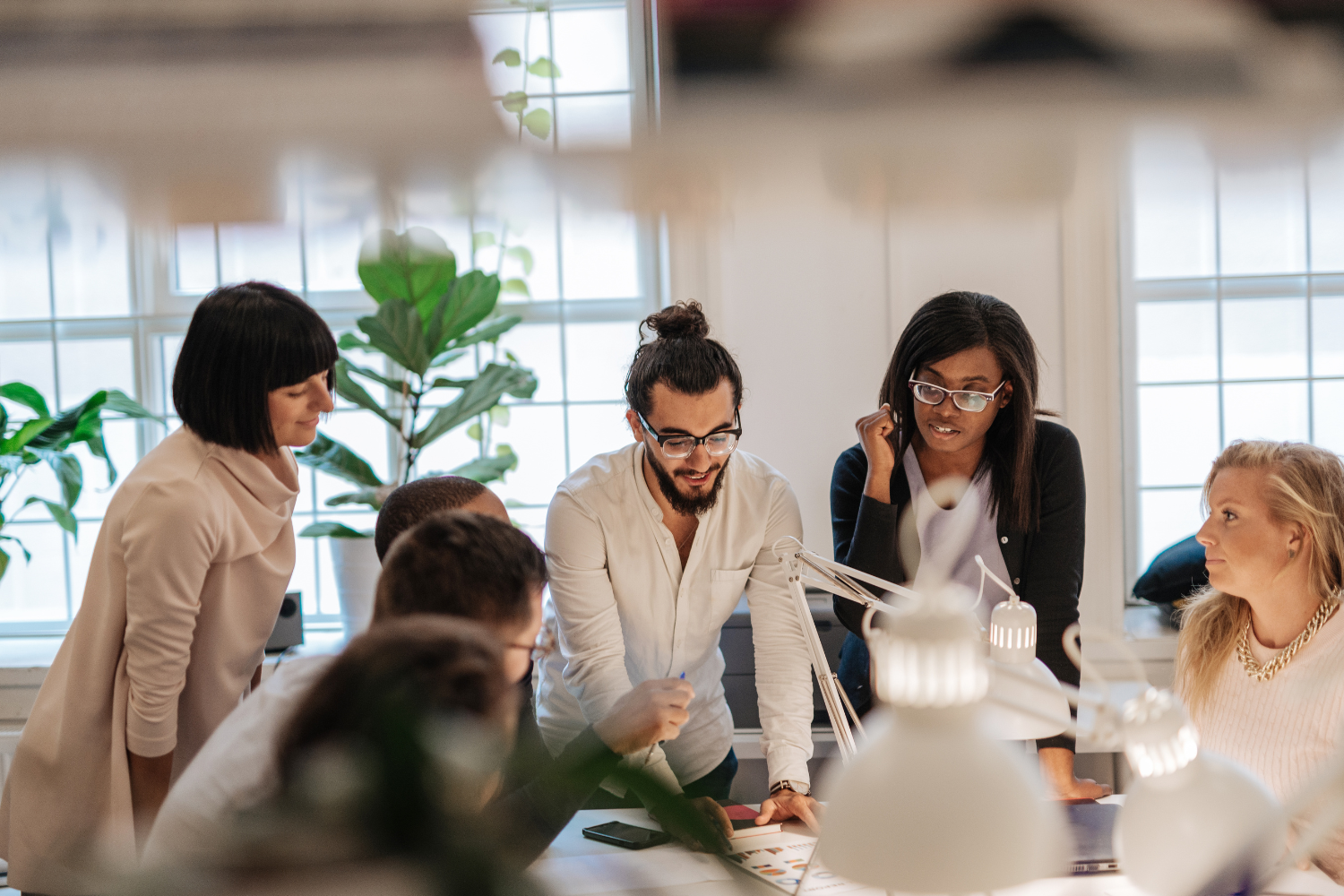 Marketing professionals discussing campaign structure and reusable tools in a planning session supported by Marketo consulting services