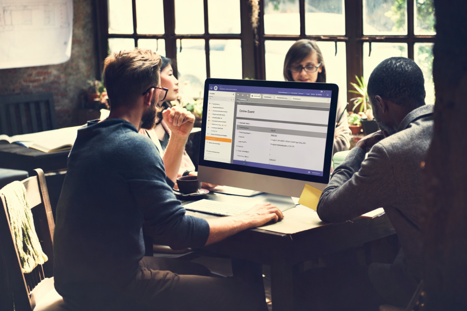 Professionals discussing Marketo program performance and campaign setup through Marketo consulting services.